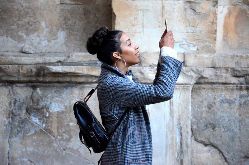iPhone 15 novedades: una mujer sacando una fotografía con su smartphone.