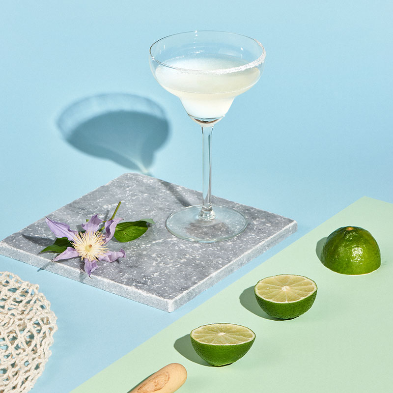 Cómo hacer cócteles sencillos para el verano: uan copa con una Margarita clásica y limas