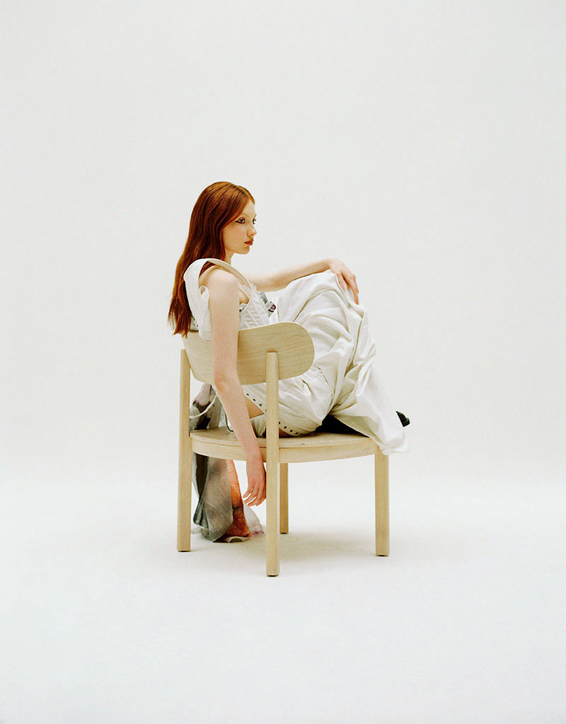 Editorial mobiliario y moda Back on 74: un modelo sentada en una silla de Teulat
