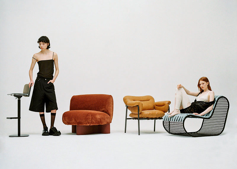 Editorial mobiliario y moda Back on 74: los dos modelos junto a una serie de piezas de mobiliario del editorial
