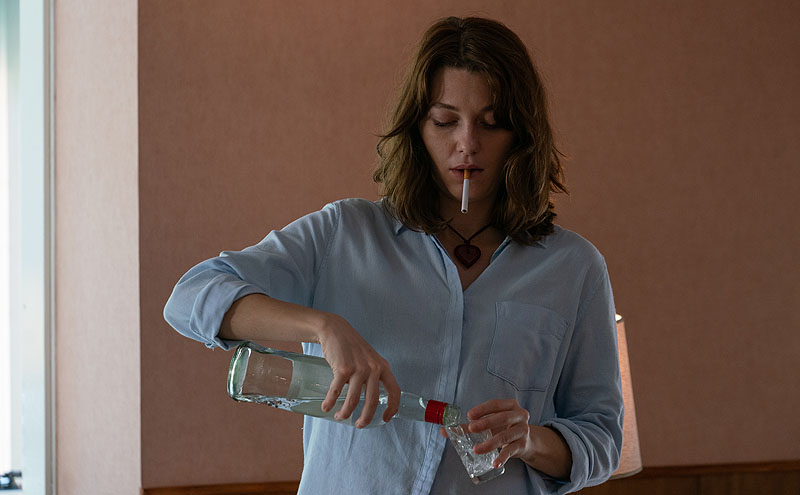El Llanto - fotograma de la película, se ve a una chica bebiendo y fumando
