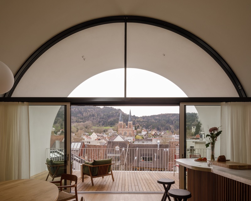 Herzog-de-Meuron-488 Kornmarktplatz: terraza del dúplex con forma de arco con vistas al pueblo y la montaña