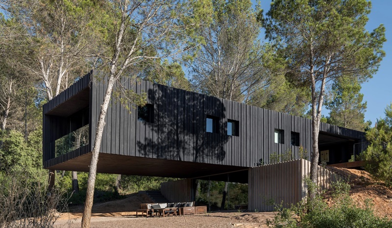 Ignacio-Borrego-Casa-Embarcadero: volumen negro de hormigón con voladizo y zona chill-out