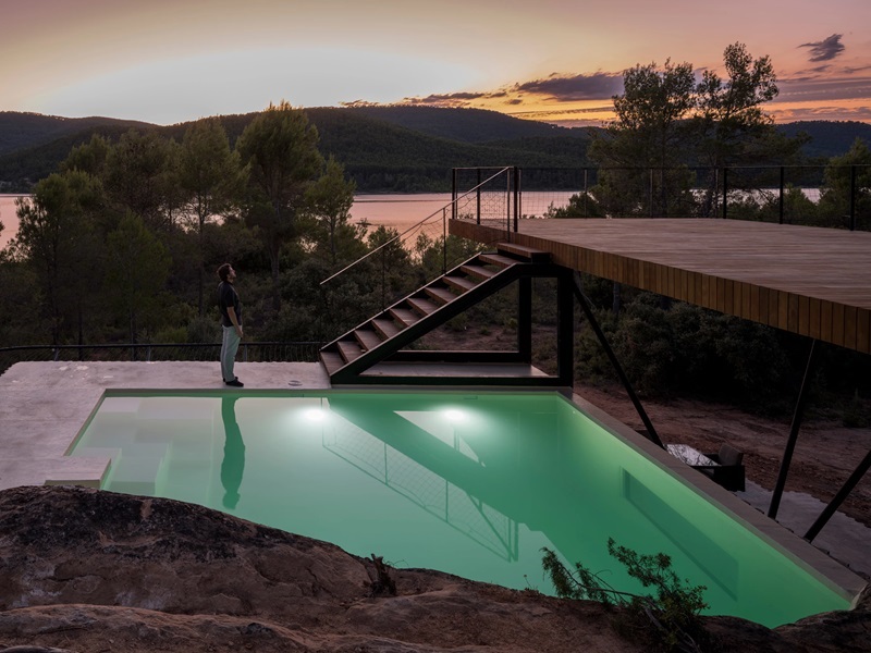 Ignacio-Borrego-Casa-Embarcadero: pasarela de madera con piscina y vistas al pantano