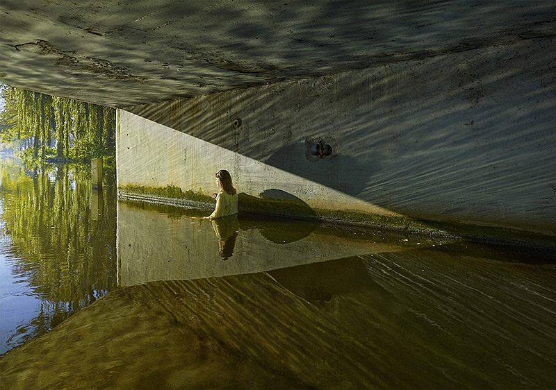 Ellen Kooi - foto de una mujer con un vestido amarillo sumergida en un canal hasta la cintura